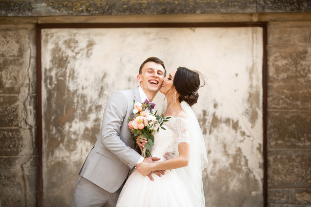 Wedding couple near historic wall at Manor on High